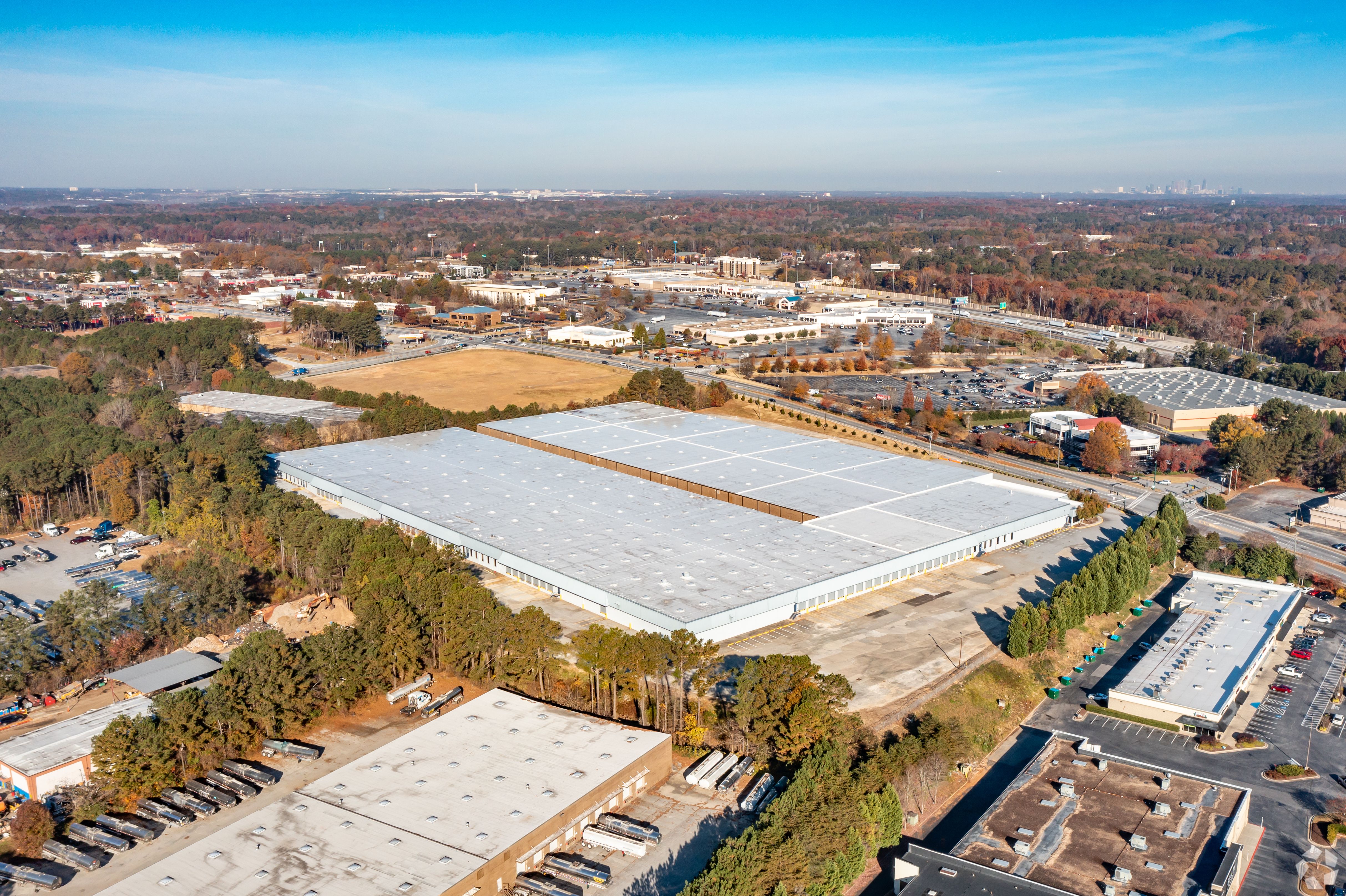 An aerial view of the Mt Zion Road property shows a large, flat grey building with trees and other industrial parks surrounding it