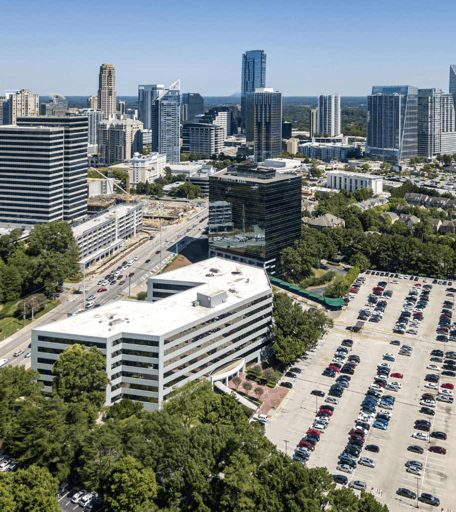 arial view of Ameris Center with Atlanta skyline behind it