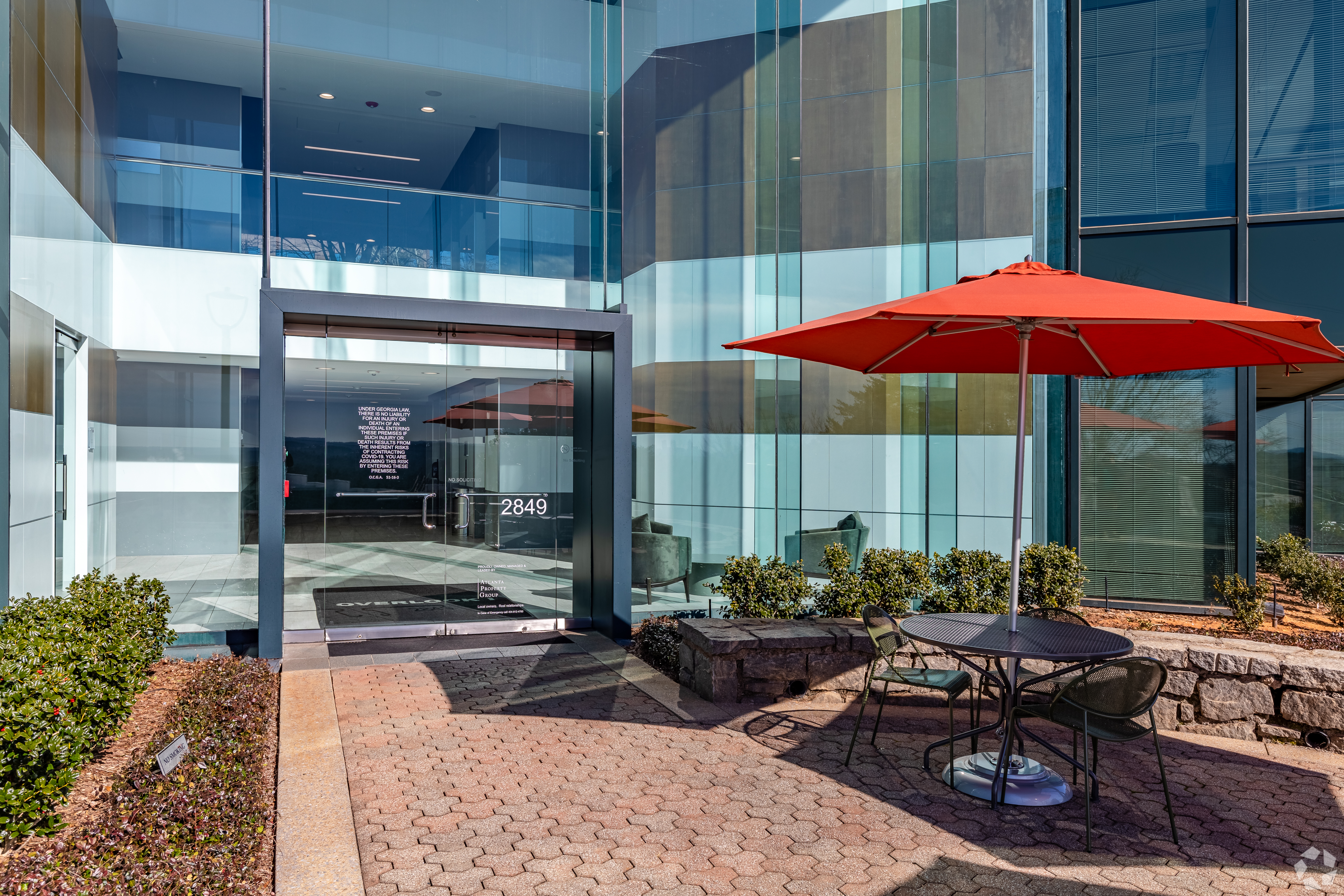 overlook I building entrance with umbrella and table to the right