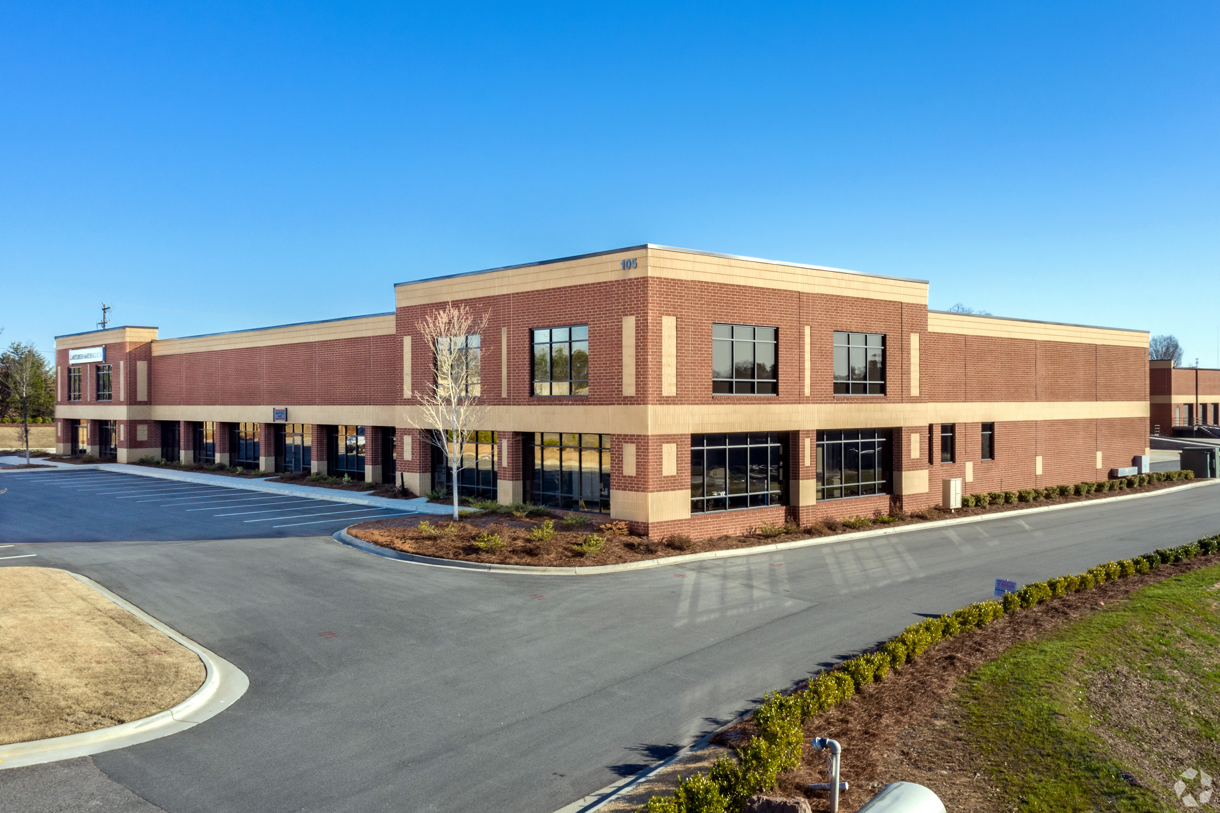 exterior of oates crossing building and parking lot